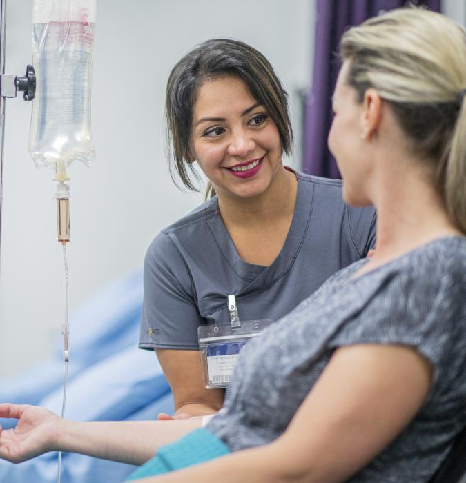 Doctor Giving IV Treatment to Patient