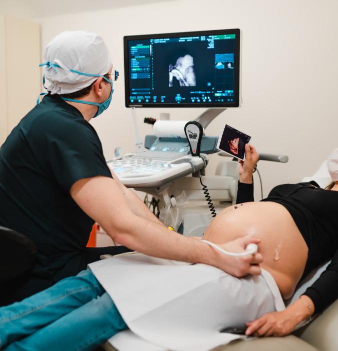 Pregnant woman watching her baby on the ultrasound