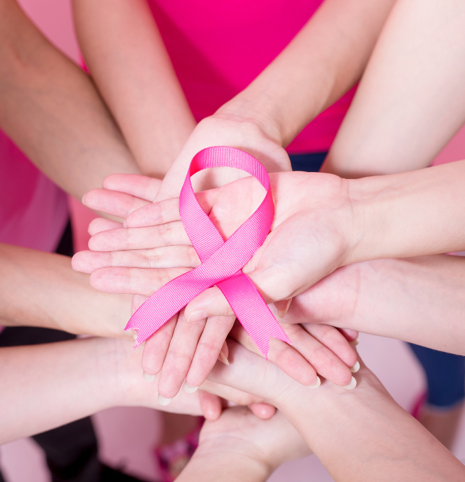 Hands with breast cancer ribbon