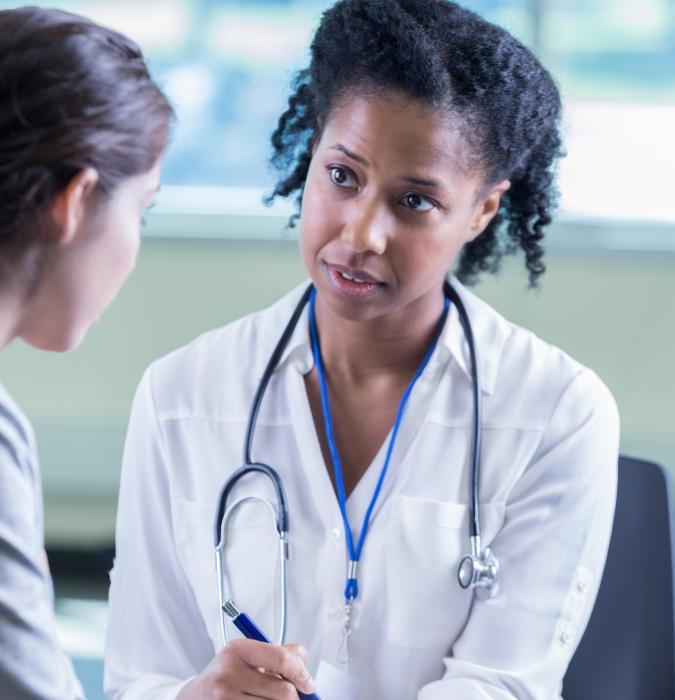 Caregiver physician listens to patient with compassion 